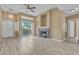Bright open floor plan with fireplace, wood-style flooring and patio access at 3544 Desert Cliff St # 102, Las Vegas, NV 89129