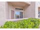 Condo patio with sliding glass door overlooking manicured landscaping at 3544 Desert Cliff St # 102, Las Vegas, NV 89129