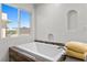 Bright bathroom with a soaking tub, natural light, and neutral color palette at 3568 Antigua Ave, Las Vegas, NV 89121