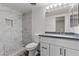 A modern bathroom features marble tile, a step-in shower, and updated vanity at 3568 Antigua Ave, Las Vegas, NV 89121