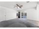 Neutral bedroom with wood look flooring, ceiling fan, and access to screened patio at 3568 Antigua Ave, Las Vegas, NV 89121