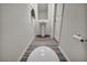 Modern half-bathroom features pedestal sink and stylish wood-look flooring at 3725 Celesta Vista Ave, Henderson, NV 89044
