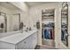 Bright bathroom with a white vanity, large mirror, and convenient walk-in closet for ample storage at 3725 Celesta Vista Ave, Henderson, NV 89044