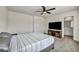Cozy bedroom with a TV, a connected door to a bathroom and a ceiling fan at 3725 Celesta Vista Ave, Henderson, NV 89044