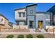 Striking two-story townhome showcases modern architecture, a yellow front door, and manicured landscaping at 3725 Celesta Vista Ave, Henderson, NV 89044