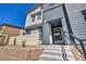 Inviting townhouse exterior featuring stairs leading up to a charming entry with decorative landscaping at 3725 Celesta Vista Ave, Henderson, NV 89044