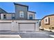Modern two-car garage with a neutral color scheme, carriage lights and drought tolerant landscaping at 3725 Celesta Vista Ave, Henderson, NV 89044