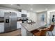 Modern kitchen featuring stainless steel appliances, a large island, and wood grain floors at 3725 Celesta Vista Ave, Henderson, NV 89044