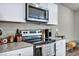 Modern kitchen showcasing stainless steel appliances, ample counter space, and custom white cabinetry at 3725 Celesta Vista Ave, Henderson, NV 89044