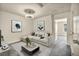 Bright living room with a modern ceiling fan, neutral walls, and a comfortable white sofa at 3725 Celesta Vista Ave, Henderson, NV 89044