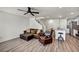Open concept living space with a leather couch, laminate flooring, and natural light at 3725 Celesta Vista Ave, Henderson, NV 89044
