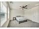Simple bedroom with natural light from a large window, ceiling fan, and minimalist decor at 3725 Celesta Vista Ave, Henderson, NV 89044