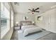 Serene bedroom with large windows, ceiling fan, and stylish neutral-toned decor at 3725 Celesta Vista Ave, Henderson, NV 89044