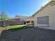 Backyard area featuring gravel, a patch of artificial turf, and a covered patio at 3836 Quail Creek Dr, North Las Vegas, NV 89032