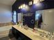 Bathroom featuring a tub, double vanity, and arched window providing natural light at 3836 Quail Creek Dr, North Las Vegas, NV 89032