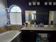 Bathroom featuring a tub, double vanity, and arched window providing natural light at 3836 Quail Creek Dr, North Las Vegas, NV 89032