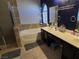 Bathroom featuring a tub, double vanity, and arched window providing natural light at 3836 Quail Creek Dr, North Las Vegas, NV 89032