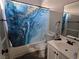 Standard bathroom with a shower-tub combo, blue shower curtain, and vanity sink at 3836 Quail Creek Dr, North Las Vegas, NV 89032