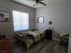 Bedroom features a ceiling fan, window with blinds, and a simple decor at 3836 Quail Creek Dr, North Las Vegas, NV 89032