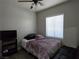 Cozy bedroom with a ceiling fan, plush bedding, and ample natural light at 3836 Quail Creek Dr, North Las Vegas, NV 89032