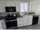 Updated kitchen with white cabinetry, subway tile backsplash, and stainless steel appliances at 3836 Quail Creek Dr, North Las Vegas, NV 89032