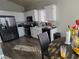 Modern kitchen featuring stainless steel appliances, white cabinets, and hardwood floors at 3836 Quail Creek Dr, North Las Vegas, NV 89032