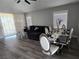 Open-concept living area with hardwood floors, dining set, and access to the backyard at 3836 Quail Creek Dr, North Las Vegas, NV 89032