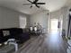 Spacious living room featuring hardwood floors, dining area and a comfortable sofa at 3836 Quail Creek Dr, North Las Vegas, NV 89032