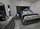 Stylish main bedroom featuring a decorative headboard, modern furniture, and great lighting at 3836 Quail Creek Dr, North Las Vegas, NV 89032