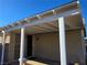 Covered patio featuring white support pillars and a sliding glass door entry offers a relaxing outdoor space at 3836 Quail Creek Dr, North Las Vegas, NV 89032