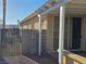 Covered patio with block wall and iron gate creates a semi-private outdoor space with access to the home at 3836 Quail Creek Dr, North Las Vegas, NV 89032