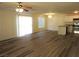 A bright living room features new wood floors, a ceiling fan, and sliding door access to a patio at 3916 Via Lucia Dr, Las Vegas, NV 89115