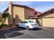 Well-maintained two-story exterior with a garage and a white car parked in the driveway at 4019 Delos Dr, Las Vegas, NV 89103
