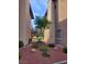Well-manicured landscaping with a decorative tree, rocks and shrubs between two buildings at 4019 Delos Dr, Las Vegas, NV 89103