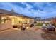 Spacious backyard showcasing a covered patio, outdoor seating, and attractive landscaping at 422 Tanita Ct, Las Vegas, NV 89123