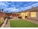 Enjoy this backyard with a covered patio, cozy seating, synthetic grass and desert landscaping at 422 Tanita Ct, Las Vegas, NV 89123