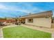 Enjoy this backyard with a covered patio, cozy seating, synthetic grass and desert landscaping at 422 Tanita Ct, Las Vegas, NV 89123