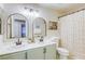Well-lit bathroom featuring dual sinks, decorative mirrors, and a shower-tub combination at 422 Tanita Ct, Las Vegas, NV 89123