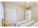 Bright bedroom with a striped bedspread, sliding closet doors, and minimalist decor at 422 Tanita Ct, Las Vegas, NV 89123