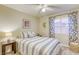 Charming bedroom with a patterned bedspread, bedside table, and bright natural light at 422 Tanita Ct, Las Vegas, NV 89123