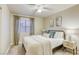 This bedroom features a ceiling fan, natural light, and stylish, neutral decor at 422 Tanita Ct, Las Vegas, NV 89123