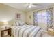 This bedroom features a ceiling fan, natural light, and stylish, neutral decor at 422 Tanita Ct, Las Vegas, NV 89123