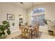 Cozy dining room with a chandelier and an adjacent kitchen creates a comfortable space at 422 Tanita Ct, Las Vegas, NV 89123