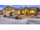 Inviting single-story home with a well-manicured yard, stone accents, and warm lighting at 422 Tanita Ct, Las Vegas, NV 89123