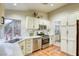 Well-lit kitchen boasts stainless steel appliances, white cabinets, and access to the dining room at 422 Tanita Ct, Las Vegas, NV 89123