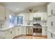Updated kitchen featuring stainless steel appliances, white cabinets, and ample natural light at 422 Tanita Ct, Las Vegas, NV 89123