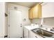 Well-lit laundry room featuring a modern washer and dryer set and convenient storage at 422 Tanita Ct, Las Vegas, NV 89123
