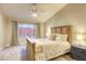 Comfortable main bedroom with a large bed, natural light, and neutral tones for relaxation at 422 Tanita Ct, Las Vegas, NV 89123