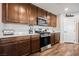 A modern kitchen featuring stainless steel appliances, warm wood cabinetry, and a clean, white countertop at 4243 Tarim St, Las Vegas, NV 89147