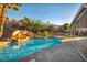 Sparkling pool with a rock waterfall, surrounded by palm trees, creating a tranquil oasis at 430 Wickenburg St, Henderson, NV 89015